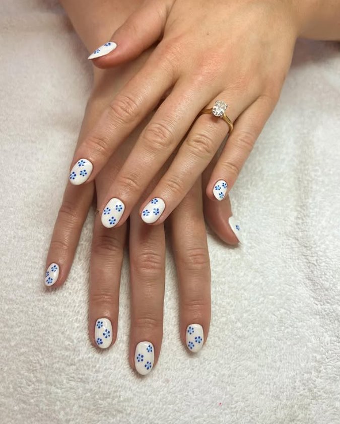 Charming Blue Floral Accents on White Nails