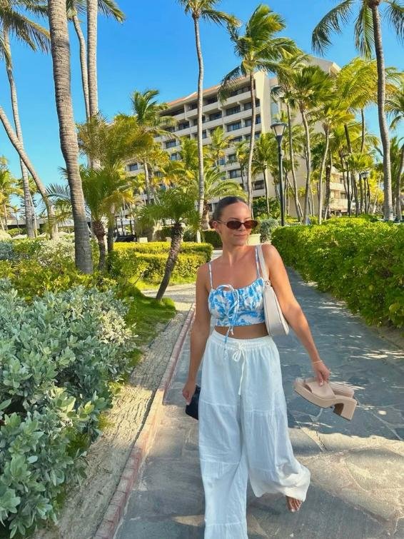 Blue floral top, white pants