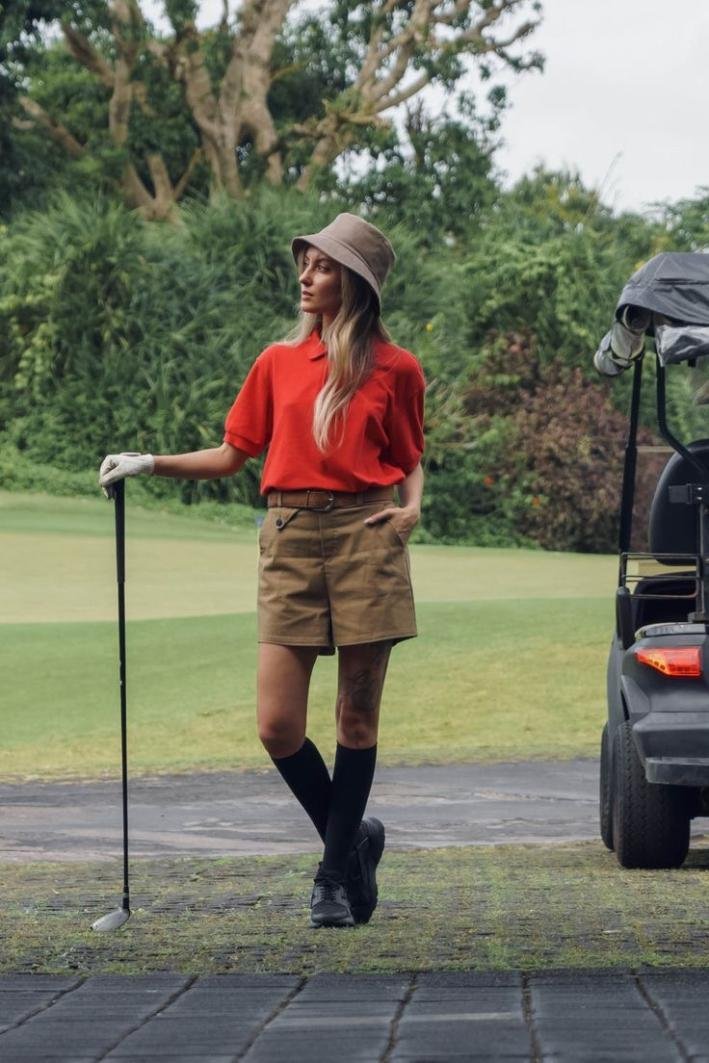 Red polo with brown shorts