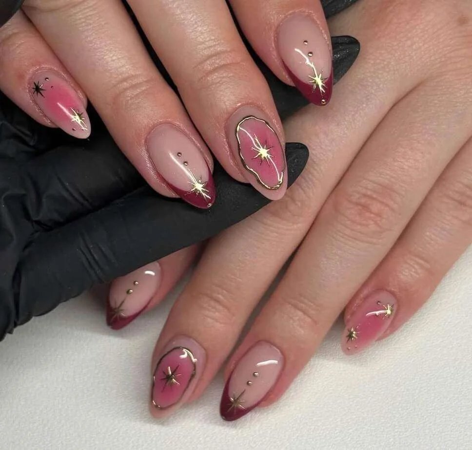 Burgundy and gold almond nails