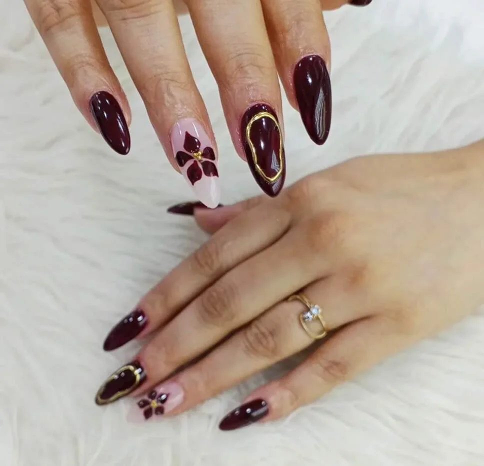 Burgundy floral accent nails