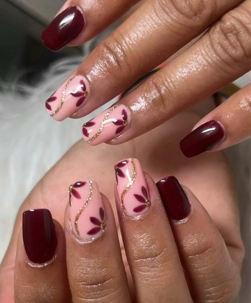 Maroon and gold floral nails