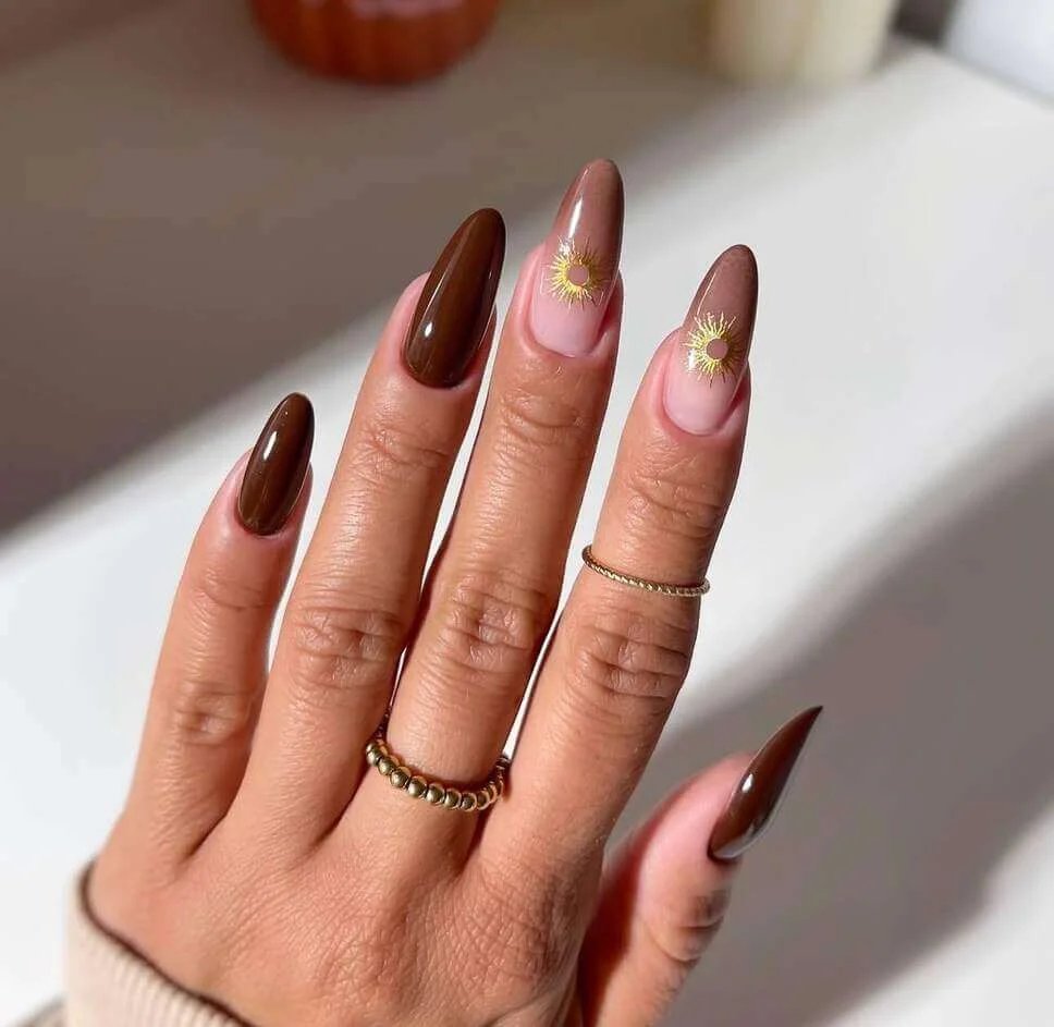 Brown nails with gold suns